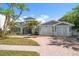 Charming two-story coastal home with a paver driveway and an attached two-car garage at 901 Bay Esplanade, Clearwater Beach, FL 33767