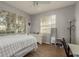 Bright bedroom with natural light, wood floors, a ceiling fan and a large dresser at 9233 Souchak Dr, Trinity, FL 34655
