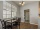 Light and airy dining room features wood floors and a view into the laundry room at 9233 Souchak Dr, Trinity, FL 34655