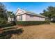 Charming single-story home with tile roof, lush landscaping, and manicured lawn, located in a sunny locale at 9233 Souchak Dr, Trinity, FL 34655