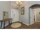 Welcoming foyer with stylish lighting, a modern table, and wood-look laminate flooring at 9233 Souchak Dr, Trinity, FL 34655