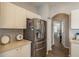 Kitchen area with stainless steel refrigerator and bright white cabinetry at 9233 Souchak Dr, Trinity, FL 34655