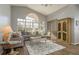 Bright living room with a large arched window, stylish furnishings, and wood flooring at 9233 Souchak Dr, Trinity, FL 34655