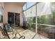 Enclosed patio with comfortable seating, offering a private and serene outdoor space at 9233 Souchak Dr, Trinity, FL 34655