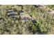 Aerial view of the home nestled among trees, with a long driveway and well-maintained landscaping at 9318 Heritage Oak Ct, Tampa, FL 33647
