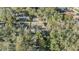Aerial view of the home nestled among trees, with a long driveway and well-maintained landscaping at 9318 Heritage Oak Ct, Tampa, FL 33647