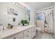 Well-lit bathroom featuring double vanity, and tiled floors at 9318 Heritage Oak Ct, Tampa, FL 33647