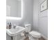 Cozy powder room featuring a pedestal sink, modern fixtures, and a decorative mirror at 9318 Heritage Oak Ct, Tampa, FL 33647