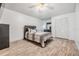 Bright bedroom featuring wood flooring, ceiling fan and closet at 9318 Heritage Oak Ct, Tampa, FL 33647