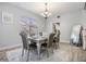 Cozy dining room with a modern table, six chairs, and a large window for natural light at 9318 Heritage Oak Ct, Tampa, FL 33647