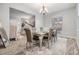 Elegant dining room with a stylish table, chairs, chandelier, and a plush white rug at 9318 Heritage Oak Ct, Tampa, FL 33647