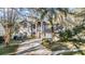 Two story home featuring an arched entryway, large windows, a two car garage and manicured landscaping at 9318 Heritage Oak Ct, Tampa, FL 33647