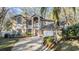 Two story home featuring an arched entryway, large windows, a two car garage and manicured landscaping at 9318 Heritage Oak Ct, Tampa, FL 33647