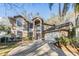 Two story home featuring an arched entryway, large windows, a two car garage and manicured landscaping at 9318 Heritage Oak Ct, Tampa, FL 33647