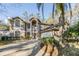 Charming two-story home features a manicured lawn, mature trees, and a welcoming entrance at 9318 Heritage Oak Ct, Tampa, FL 33647