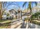 Beautiful two-story home boasts a manicured lawn, mature trees, and a two car garage at 9318 Heritage Oak Ct, Tampa, FL 33647