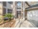 Close up view of the front door, surrounded by pillars, glass brick and trimmed landscaping at 9318 Heritage Oak Ct, Tampa, FL 33647