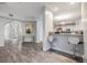 Open hallway connecting to the kitchen, featuring modern flooring, neutral paint, and stylish decor at 9318 Heritage Oak Ct, Tampa, FL 33647