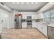 Spacious kitchen with stainless steel appliances, white cabinets, and modern countertops at 9318 Heritage Oak Ct, Tampa, FL 33647