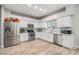 Well-lit kitchen with stainless steel appliances, white cabinets, subway tile backsplash, and plenty of counter space at 9318 Heritage Oak Ct, Tampa, FL 33647