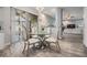 Sunlit kitchen with a glass dining table and chairs, and a sliding door to a screened in room at 9318 Heritage Oak Ct, Tampa, FL 33647