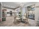 Bright kitchen with stainless steel appliances, modern countertops, and a glass-top dining table with stylish chairs at 9318 Heritage Oak Ct, Tampa, FL 33647