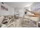 Bright living room with a white baby grand piano, elegant furniture, and staircase at 9318 Heritage Oak Ct, Tampa, FL 33647