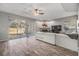 Open living room with modern furniture, fireplace, and sliding glass doors leading to an enclosed porch at 9318 Heritage Oak Ct, Tampa, FL 33647