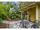 Backyard with stone patio and mature tropical landscaping at 1045 6Th N St, St Petersburg, FL 33701