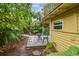 Lush tropical backyard with patio area and adjacent yellow cottage at 1045 6Th N St, St Petersburg, FL 33701