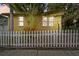 Inviting front yard with a white picket fence and a tropical palm tree, adding charm and privacy to the property at 1045 6Th N St, St Petersburg, FL 33701