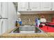 Close-up of the kitchen sink featuring granite countertop and stainless steel fixtures at 1045 6Th N St, St Petersburg, FL 33701