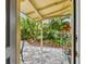 Private outdoor patio with lush greenery and stone tile at 1045 6Th N St, St Petersburg, FL 33701