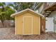 Small, painted shed with a gravel foundation and simple door, providing functional storage for the property at 1045 6Th N St, St Petersburg, FL 33701