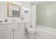 This bathroom has a shower-tub combo and a vanity with gold hardware at 10925 124Th Ave, Largo, FL 33778