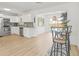 Modern kitchen with stainless steel appliances and a breakfast bar overlooking the pool at 10925 124Th Ave, Largo, FL 33778