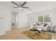 Bright living room featuring wood flooring, a ceiling fan, and an open layout at 10925 124Th Ave, Largo, FL 33778