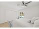 Bright main bedroom features a ceiling fan, closet, and view of the pool area at 10925 124Th Ave, Largo, FL 33778