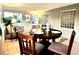 Sunroom dining area with a round wooden table and a glass block window at 1101 Canal St, Ruskin, FL 33570