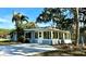 Exterior view featuring a sunroom, a well-kept lawn, and beautiful trees, providing curb appeal at 1101 Canal St, Ruskin, FL 33570