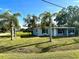 Charming single-story home featuring a well-maintained lawn, mature trees, and an inviting entrance at 1101 Canal St, Ruskin, FL 33570