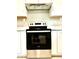 Close-up of the black stainless steel oven with white cabinets above, offering a sleek kitchen aesthetic at 1101 Canal St, Ruskin, FL 33570