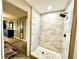 Beautifully tiled walk-in shower with a modern rain shower head and a unique mosaic tile floor in the bathroom at 1101 Canal St, Ruskin, FL 33570