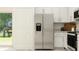 Bright kitchen featuring stainless steel refrigerator and white cabinetry at 11251 E 65Th Ter, Palmetto, FL 34221