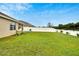 This large, grassy backyard with a white vinyl fence is perfect for outdoor entertaining at 12018 Gillingham Harbor Ln, Gibsonton, FL 33534