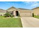 Charming single-story home with a well-manicured lawn and inviting front entrance at 12018 Gillingham Harbor Ln, Gibsonton, FL 33534