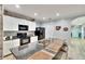 Kitchen island featuring granite countertops, sink, seating and black appliances at 12018 Gillingham Harbor Ln, Gibsonton, FL 33534