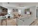 Well-lit living room featuring modern decor, a ceiling fan, and a large window with blinds at 12018 Gillingham Harbor Ln, Gibsonton, FL 33534