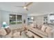 Inviting living room with neutral tones, a ceiling fan, and a view of the backyard at 12018 Gillingham Harbor Ln, Gibsonton, FL 33534