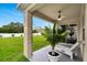 Covered patio area with ceiling fan and decorative plants; relaxing outdoor space at 12018 Gillingham Harbor Ln, Gibsonton, FL 33534